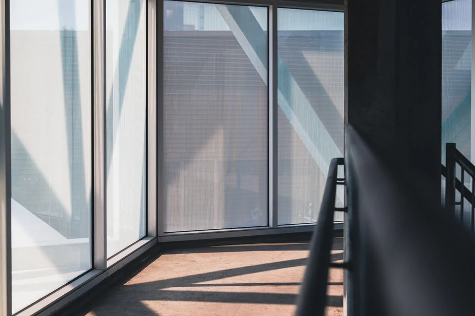 project-01-b Spacious and contemporary office interior with glass partitions, stylish furniture, and vibrant wall art.